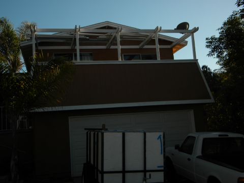 1992 Ford Bronco - A white pickup truck is visible parked to the right of a garage door, with a large white container on a trailer in front of the garage.