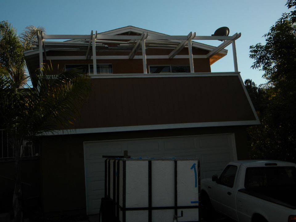 White pickup truck parked next to a garage