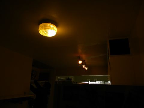 1992 Ford Bronco - A close-up view of a yellow ceiling light fixture inside a dimly lit space.