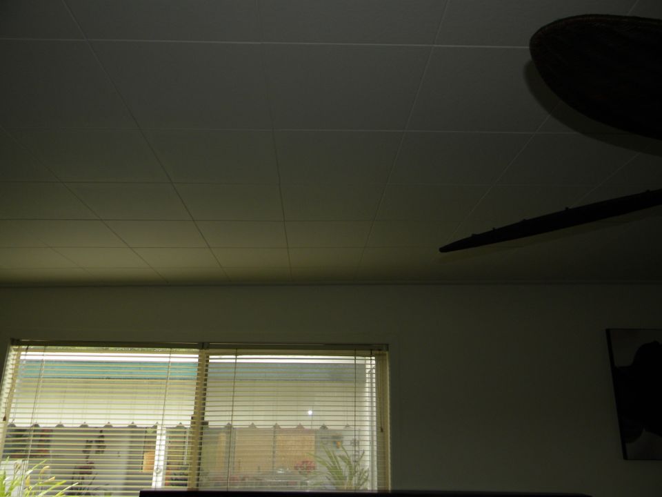 Interior scene with blinds on windows, a ceiling fan, and a "SUPERMOTORS" logo
