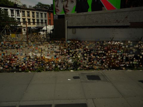 1992 Ford Bronco - A white van is partially visible behind a chain-link fence adorned with many small, colorful squares.