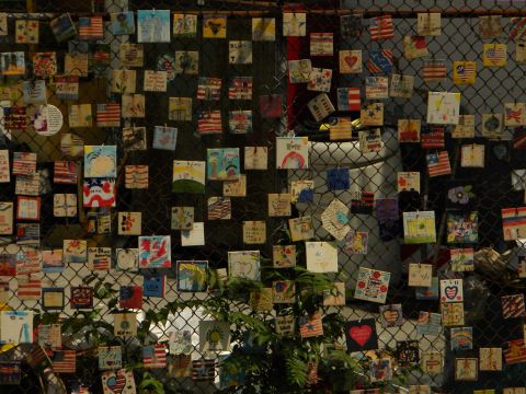 1992 Ford Bronco - Memorial tiles adorn a chain-link fence, creating a colorful and textured display.
