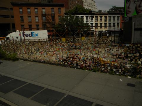 1992 Ford Bronco - A FedEx truck is visible behind a fence adorned with numerous small, square items, possibly notes or art.