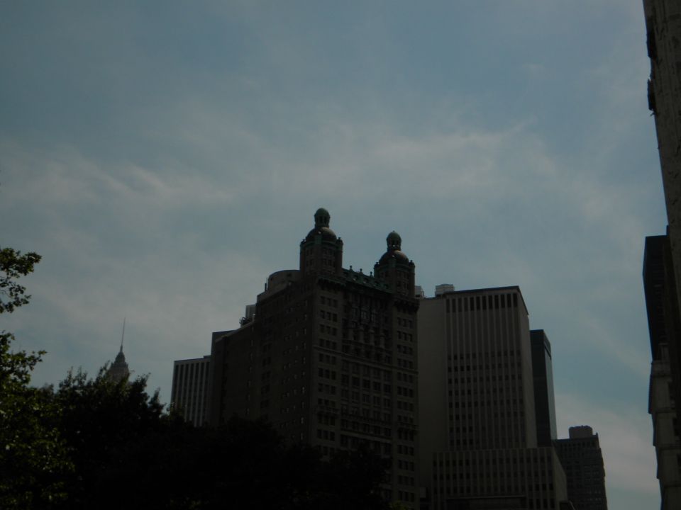 Buildings under a cloudy sky, with a Supermotors.net logo visible