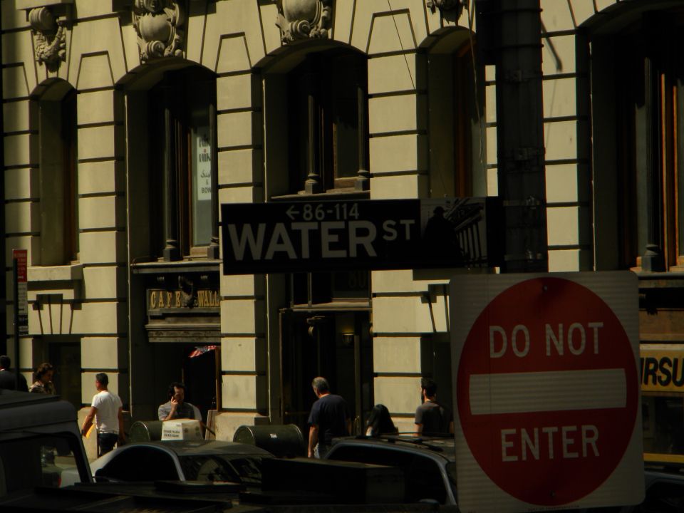 Street sign for Water St and a 'Do Not Enter' sign in front of a building