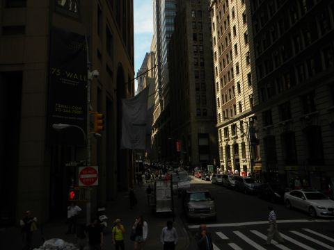 1992 Ford Bronco - A view down a city street lined with tall buildings, showing traffic and pedestrians on a sunny day.