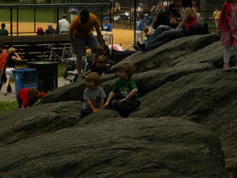 1992 Ford Bronco - Children enjoy a day at the park, climbing on large rocks near a baseball field.