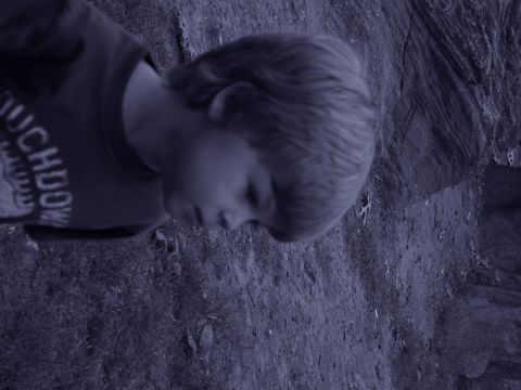 1992 Ford Bronco - A child is seen wearing a shirt with text, with a rocky background.