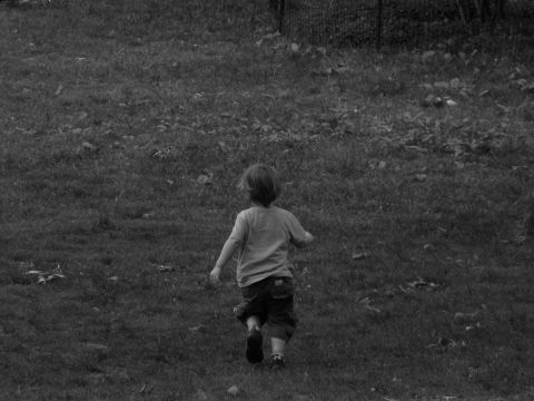 1992 Ford Bronco - Child runs across a grassy area, with a fence visible in the background.