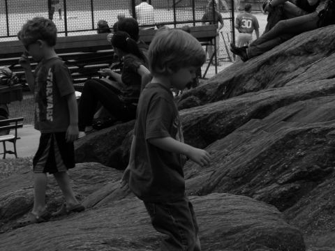 1992 Ford Bronco - Children explore a rocky area, with adults and a fence in the background.