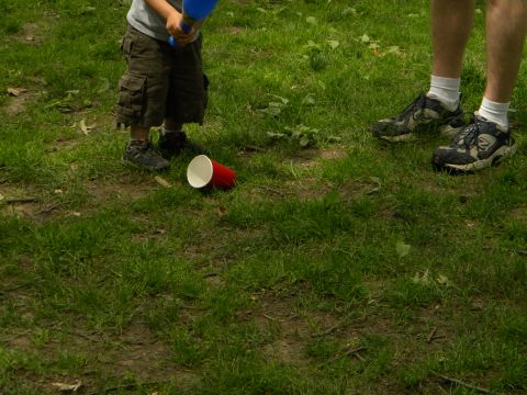 1992 Ford Bronco - A child and adult are in a grassy area with a red cup on the ground.
