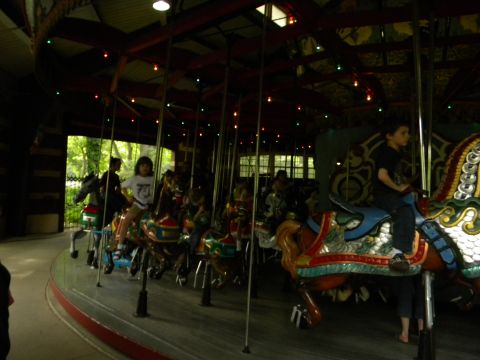 1992 Ford Bronco - Children enjoy a ride on a carousel, with multiple horses visible.