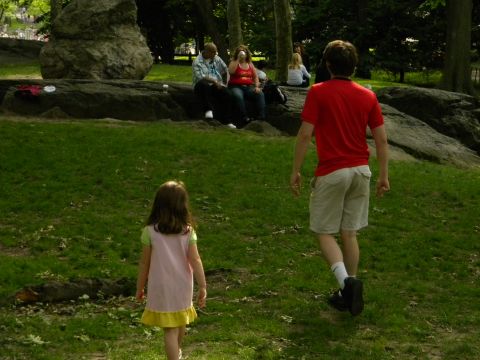 1992 Ford Bronco - A group of people enjoy a sunny day in a park, with a child and adult walking across the grass.