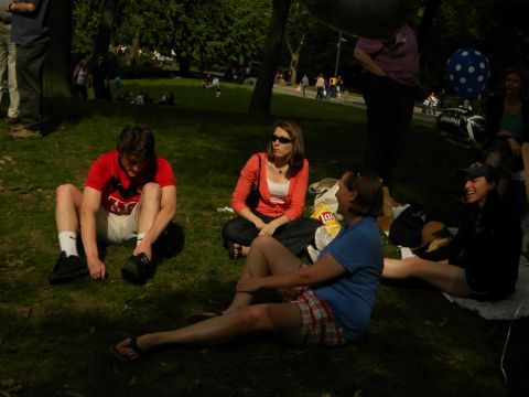 1992 Ford Bronco - People enjoying a sunny day in the park, sitting on the grass.