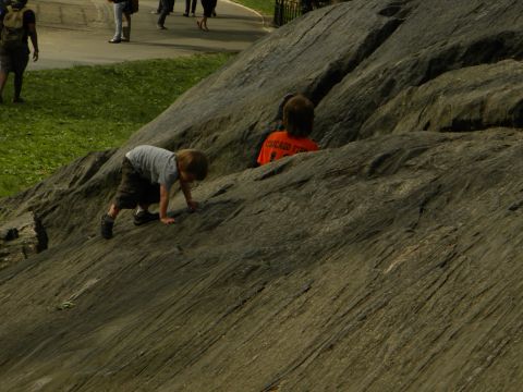 1992 Ford Bronco - Children explore a rocky terrain, with other park-goers visible in the distance.