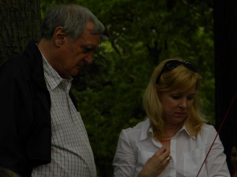 1992 Ford Bronco - A man and a woman are seen outdoors, with a focus on their downward gaze. The scene is set against a backdrop of trees.