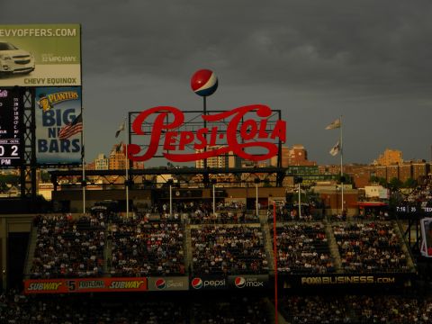 1992 Ford Bronco - A large Pepsi-Cola sign is visible above a crowded stadium, with advertisements on the scoreboard.