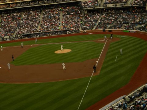 1992 Ford Bronco - A baseball game is in progress with players on the field and a crowd in the stands.