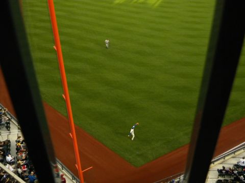1992 Ford Bronco - A baseball player makes a catch during a game, viewed from stadium seating.