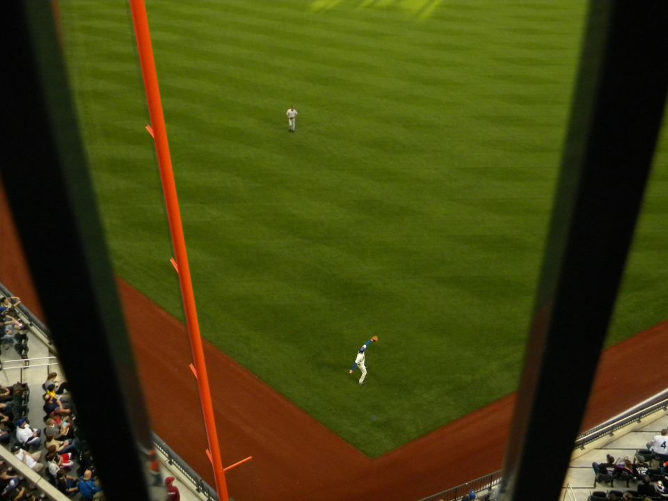 baseball player catching a ball on a field, seen from above