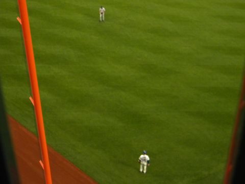 1992 Ford Bronco - A baseball field is viewed from above, with two players on the grass and an orange pole on the left.