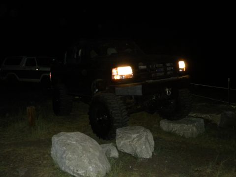 1992 Ford Bronco - Lifted 1992 Ford Bronco on rocks at night, with another Bronco in the background.