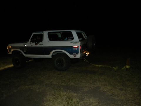 1992 Ford Bronco - This lifted Ford Bronco, likely from the late 1970s, is shown at night with its headlights on.