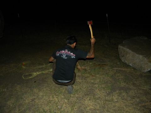 1992 Ford Bronco - Man holding an axe in a dark outdoor setting near a large rock.