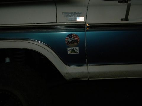 1992 Ford Bronco - A 1992 Ford Bronco is shown from the side, displaying its two-tone paint and various decals.