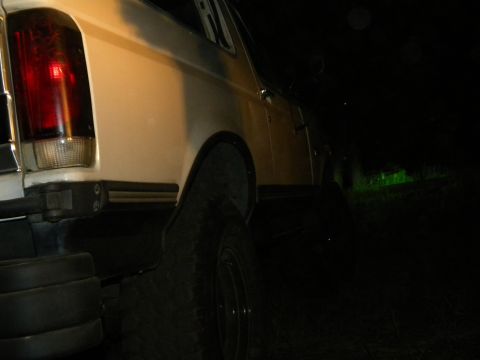 1992 Ford Bronco - Rear view of a 1992 Ford Bronco at night, showing the taillight and quarter panel.