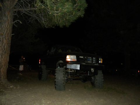 1992 Ford Bronco - This lifted 1992 Ford Bronco is parked outdoors at night, showing its front view.