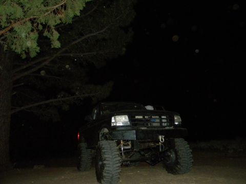 1992 Ford Bronco - A modified 1992 Ford Bronco is seen at night with its front end facing the camera.