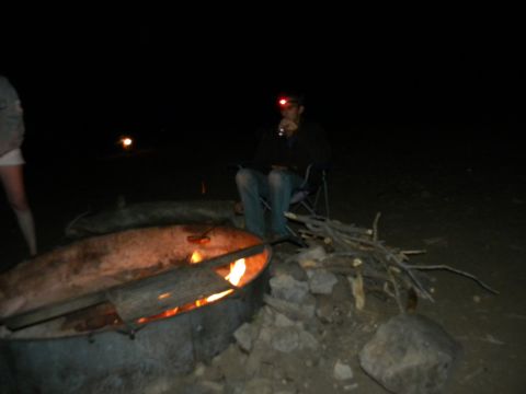 1992 Ford Bronco - Campfire scene at night with people sitting around the fire.