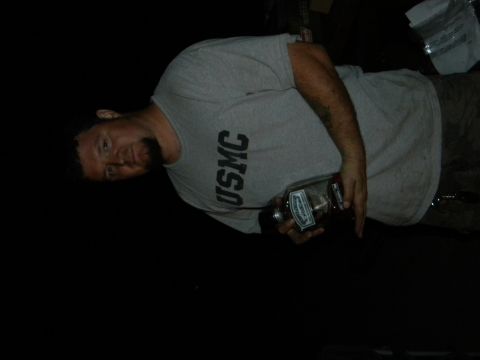1992 Ford Bronco - Man in USMC shirt holding a bottle, Supermotors.net watermark visible.