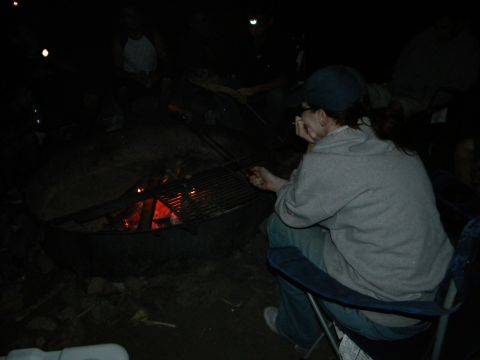 1992 Ford Bronco - A group of people are gathered around a campfire, with one person in the foreground sitting in a chair.