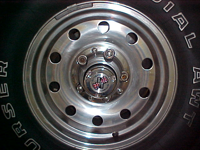 Polished ten-hole aluminum wheel with manual locking hub and Courser Radial AWT tire