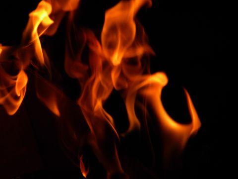 1992 Ford Bronco - A close-up view of bright orange and yellow flames flickering against a black background.