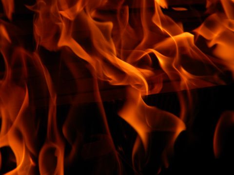 1992 Ford Bronco - A close-up view of a large fire with bright orange and yellow flames.