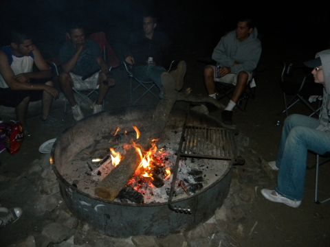 1992 Ford Bronco - A group of people are enjoying a bonfire in the dark.