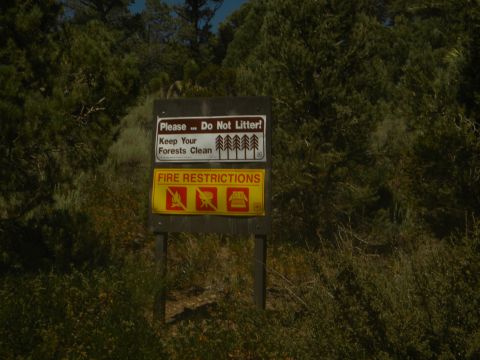 1992 Ford Bronco - Signage in a natural setting provides information about littering and fire restrictions.