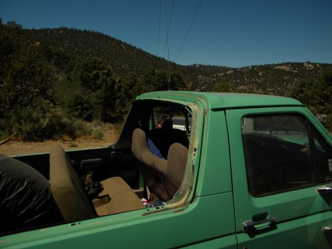 1992 Ford Bronco - Interior view of a green pickup truck parked outdoors with a scenic mountain backdrop.
