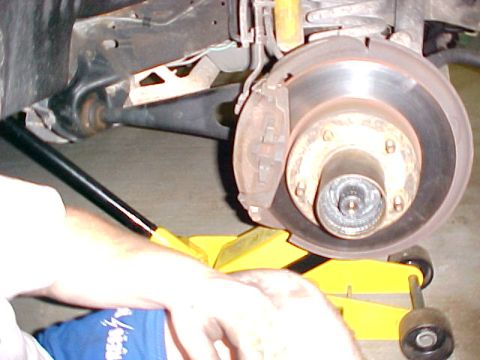 1996 Ford Bronco - Close-up view of a vehicle's brake rotor and suspension components.