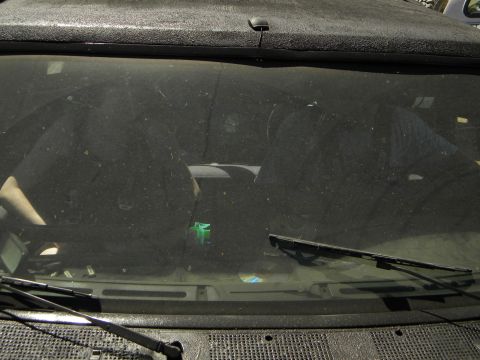 1992 Ford Bronco - View from inside a dusty vehicle, showing the dashboard and windshield wipers.