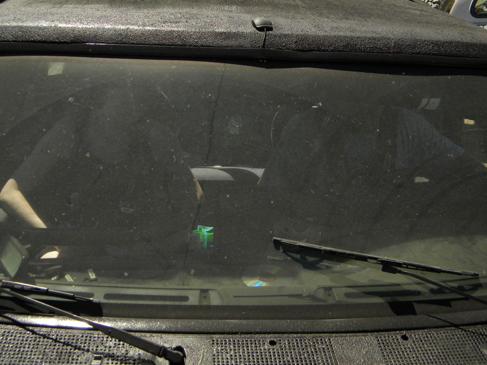 Dusty vehicle interior with dashboard and windshield wipers