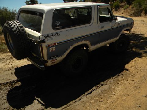 1992 Ford Bronco - This 1978 Ford Bronco is parked on a dirt road, showing its rear-mounted spare tire.
