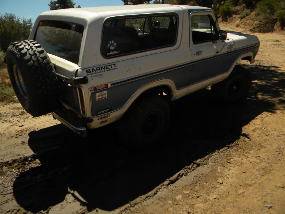 1978 Ford Bronco with spare tire on rear, parked on dirt road