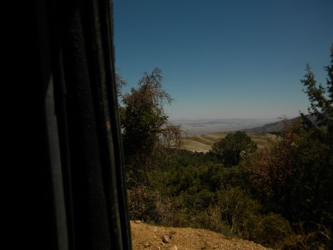 1992 Ford Bronco - A scenic view of rolling hills and distant haze, seen from inside a vehicle.