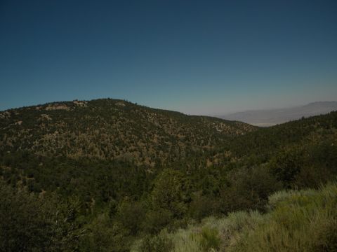 1992 Ford Bronco - A wide view of a mountainous area with sparse vegetation and a clear sky above.