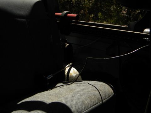 1992 Ford Bronco - A close-up view of the interior of a vehicle, focusing on the seat and roll bar structure.