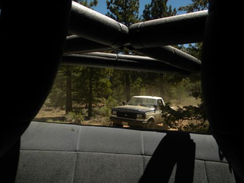 1992 Ford Bronco - A 1992 Ford F-150 pickup truck kicks up dust as it drives through a wooded area.